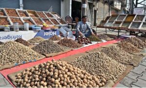 A vendor selling dry fruit on his roadside setup at City road.