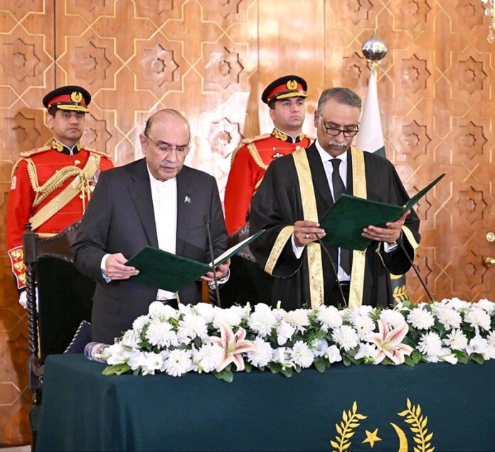 President Asif Ali Zardari administering the oath of office to Mr Justice Sardar Muhammad Sarfraz Dogar as the Acting Chief Justice of Islamabad High Court, at Aiwan-e-Sadr