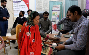 A doctor examining a patient during Free Medical Camp organized by HUJ at Press club