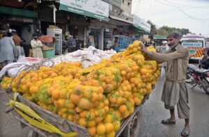 A worker loading supplies on his pushcart at Shaheen Chowk.