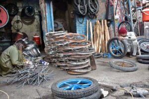 A tire mechanic skillfully repairs wheels at his workshop in the provincial capital.