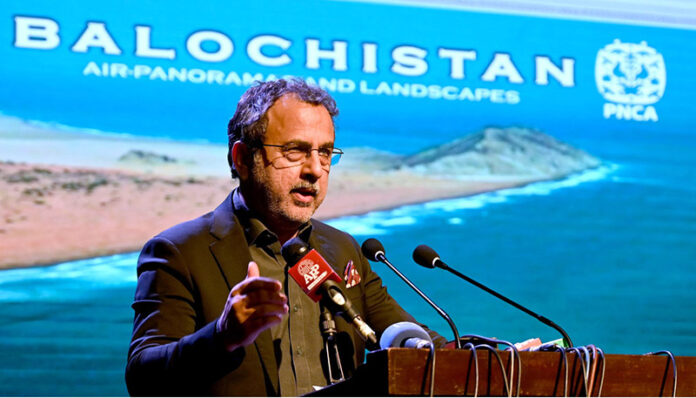 Federal Minister of Energy Sardar Awais Ahmed Khan Leghari addresses the audience at the launch of a coffee table book and large-format photo exhibition in the federal capital