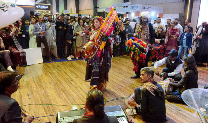 Folk singer Taj Mastani presenting her performance at the PIA stall during the third day of Pakistan Travel Mart at the Expo Center