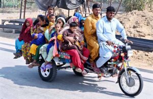 A gypsy family traveling on tricycle cart at Mohenjo-Daro Airport Road