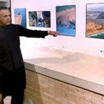 Federal Minister of Energy Sardar Awais Ahmed Khan Leghari is briefed by the organizer about the stunning landscape photographs of Balochistan at the launch of a coffee table book and large-format photo exhibition in the federal capital