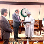 Federal Minister Jam Kamal Khan presents a book showcasing Pakistan's natural beauty to OIC Secretary-General Hissein Brahim Taha during their meeting in Jeddah, emphasizing Pakistan's commitment to strengthening economic and trade ties within the OIC in federal capital