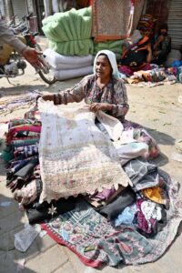 A gypsy woman sells old clothes at Jales Bazar.