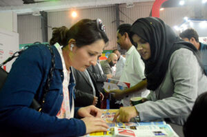 Women inquiring about the products being offered at different stalls during the third day of Pakistan Travel Mart at the Expo Center