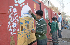 Students are busy making paintings on the wall to beautify Government Islamia High School.