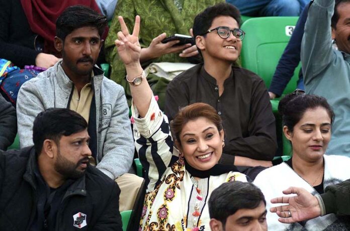 Spectators enjoy while watching first match of the Tri-Nation Series played between Pakistan and New Zealand cricket teams at Gaddafi Stadium