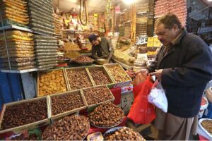 Vendor selling dry fruits to attract the customer at Fawara Chowk.