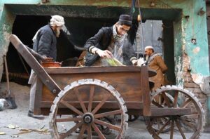 Vendor arranging corn on his hand cart to sell in the market at Lahori Chowk.
