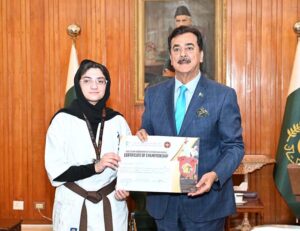 Acting President Syed Yousuf Raza Gillani giving appreciation certificate to Pakistan's Young Karate Champion Fatima Ahmed Khan at Aiwan-e-Sadr.