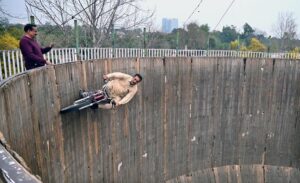 A motorcyclist demonstrates his skills while riding a motorcycle in the 'Well of Death' at the Lucky Irani Circus in F-9 Park.