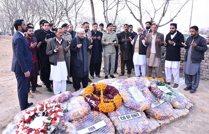 President Asif Ali Zardari offering Fateha at the grave of Major Hamza Israr Shaheed, who embraced martyrdom in North Waziristan
