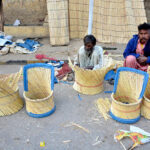 A worker busy in preparing chairs along the roadside