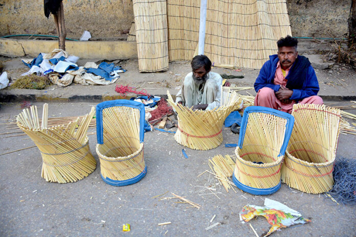 A worker busy in preparing chairs along the roadside