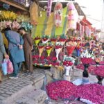 People busy in purchasing flowers from a flower stall at 47 Adda