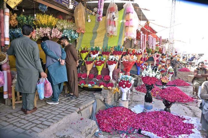 People busy in purchasing flowers from a flower stall at 47 Adda