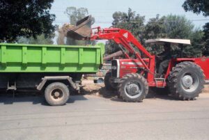 Highway Department workers are cleaning green belt on Hasilpur Main road.