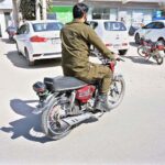 A police official is riding a motorcycle without a number plate and without wearing a safety helmet near the DPO office on Katchery Road. This is a clear violation of traffic rules and requires the immediate attention of the concerned authorities