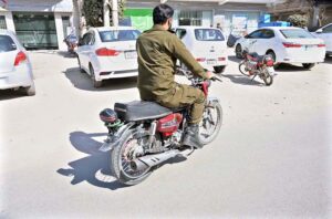 A police official is riding a motorcycle without a number plate and without wearing a safety helmet near the DPO office on Katchery Road. This is a clear violation of traffic rules and requires the immediate attention of the concerned authorities