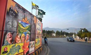 A motorcyclist walks past the banners of oppressed Kashmiris in front of the Parliament House on the occasion of Kashmir Solidarity Day, paying tribute to the resilience and sacrifices of Kashmiris in the illegally occupied Jammu and Kashmir IIOJK.