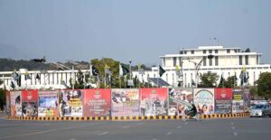 A motorcyclist walks past the banners of oppressed Kashmiris in front of the Parliament House on the occasion of Kashmir Solidarity Day, paying tribute to the resilience and sacrifices of Kashmiris in the illegally occupied Jammu and Kashmir IIOJK.