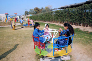 Children enjoying swing on a cradle at a local park