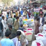 A large number of people purchasing flowers from vendors in connection with Shab-e-Barat at Flowers Market