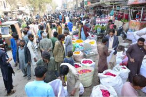 A large number of people purchasing flowers from vendors in connection with Shab-e-Barat at Flowers Market