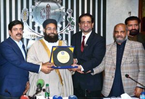 President FCCI, Mr. Rehan Naseem Bharara, presents a shield to Hafiz Muhammad Tahir Mehmood Ashrafi, Special Representative to the Prime Minister of Pakistan for Middle East on Religious Harmony, after his address at an awareness seminar on Hajj at the Faisalabad Chamber of Commerce & Industry (FCCI)