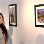 A female visitor admires a beautiful landscape photography after inaugurates the exhibition “Beautiful Japan- Through the Eyes of an Ambassador” at the National Art Gallery