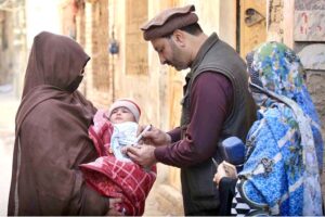 A lady health worker administering polio drops to a child during an anti-polio campaign in the city.