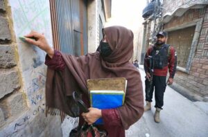 A lady health worker administering polio drops to a child during an anti-polio campaign in the city.