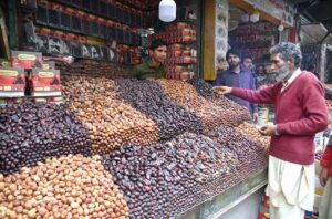 A shopkeeper attracts the attention of customers by decorating various varieties of dates in Anarkali Bazaar.
