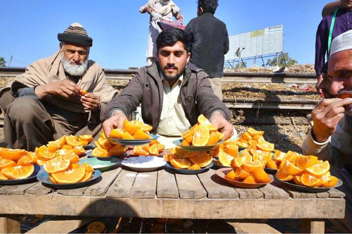 Vendor selling and displaying orange to attract the customer at Fruit Market