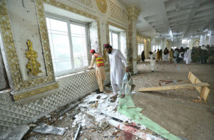 People gather at the blast site at Darul Uloom Haqqania Akora Khattak in which seven people, including Leader of JUI (S) Maulana Hamid Ul Haq Haqqani, were martyred while fifteen others injured.