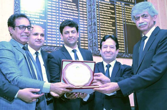 President District Bar Association Irfanullah Warraich Advocate, Secretary Chaudhry Afzal Aslam presenting a shield to renowned national poet Shahid Zaki at the annual Mehfil Mushaira