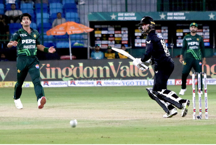 New Zealand's Devon Conway watches the ball after playing a shot during the final one-day international (ODI) cricket match of Tri-Nation series between Pakistan and New Zealand at the National Stadium