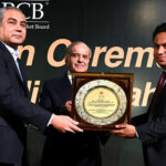 Prime Minister Muhammad Shehbaz Sharif presenting a shield award to Farhat Abbas Fakhir, Project Director, Infrastructure Department PCB in recognition of outstanding contribution and service for upgradation of Qaddafi Stadium
