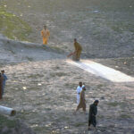 Youngsters playing cricket in the dry bed of River Ravi near Saggian pul in the Provincial Capital