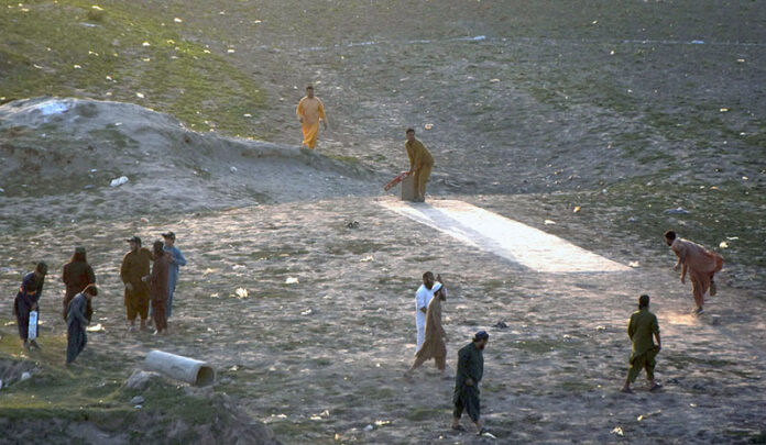Youngsters playing cricket in the dry bed of River Ravi near Saggian pul in the Provincial Capital