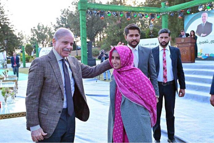 Prime Minister Muhammad Shehbaz Sharif praising career success of a graduate of Daanish School at a ceremony to mark Youm-e-Tameer-o-Taraqqi