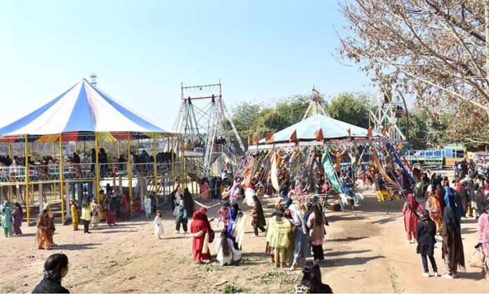 Students are enjoying swings in a funfair held at Islamabad Model College for Girls Bharakahu