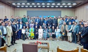 Prime Minister Muhammad Shehbaz Sharif in a group photo with participants of the Overseas Pakistanis Global Foundation convention.