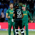 South Africa's Wiaan Mulder celebrates with teammates after taking the wicket of Pakistan's Babar Azam during the ODI cricket match of Tri-Nation series between Pakistan and South Africa at the National Stadium