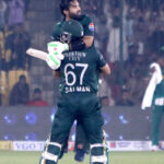 Pakistan's captain Mohammad Rizwan celebrates after scoring a century (100 runs) with Salman Agha during the ODI cricket match of Tri-Nation series between Pakistan and South Africa at the National Stadium