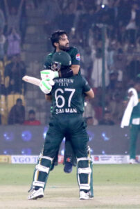 Pakistan's captain Mohammad Rizwan celebrates after scoring a century (100 runs) with Salman Agha during the ODI cricket match of Tri-Nation series between Pakistan and South Africa at the National Stadium