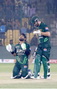 Pakistan's captain Mohammad Rizwan celebrates after scoring a century (100 runs) with Salman Agha during the ODI cricket match of Tri-Nation series between Pakistan and South Africa at the National Stadium